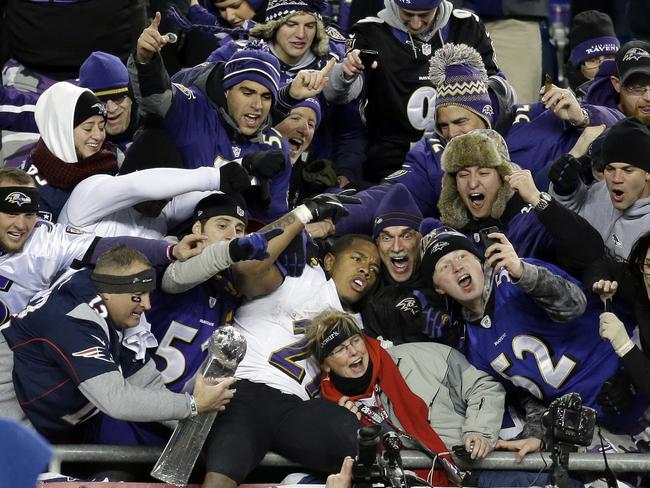Adulation turned to scorn. Sacked Baltimore Ravens running back Ray Rice, centre, is surrounded by fans as he celebrates winning an NFL football game. Picture: Steven Senne