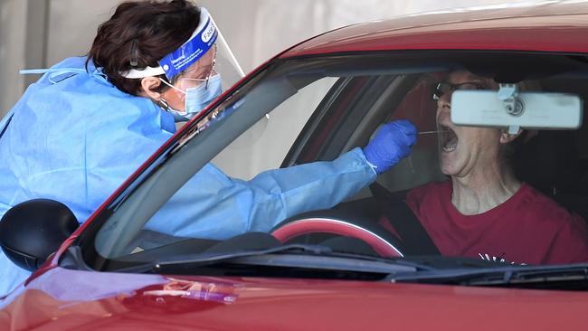 A health worker performs a Covid-19 test at a drive-through station in Brisbane earlier this month. Picture: NCA NewsWire / Dan Peled