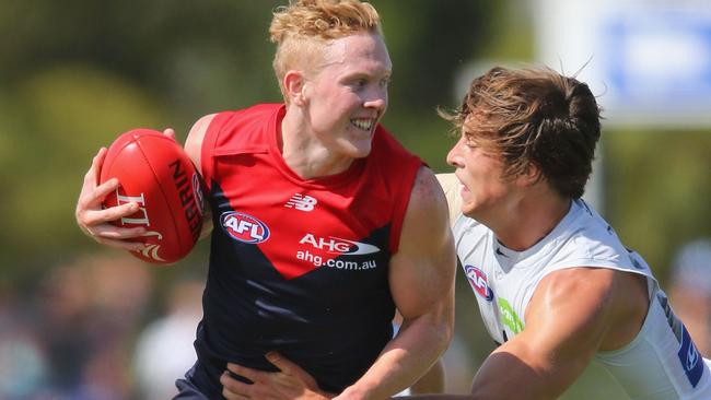 Clayton Oliver beats Caleb Marchbank to the ball. Picture: Getty Images