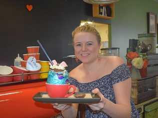 EASTER TREAT: Nothing exceeds like excess and Easter has traditionally been a time when the lean times of Lent give way to a celebration, with lots of sweet things for the children and sometimes the adults too. Farmer and Sun owner Sharla Watson shows off the store's special treat, an as-yet unnamed creation made from an Easter egg filled with chocolate thick shake. Picture: Arthur Gorrie