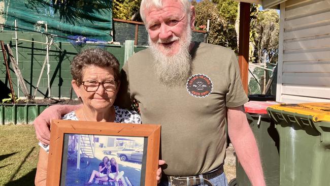 Peter and Robyn Stace hold a picture of Lee Ellen Stace and her sister.