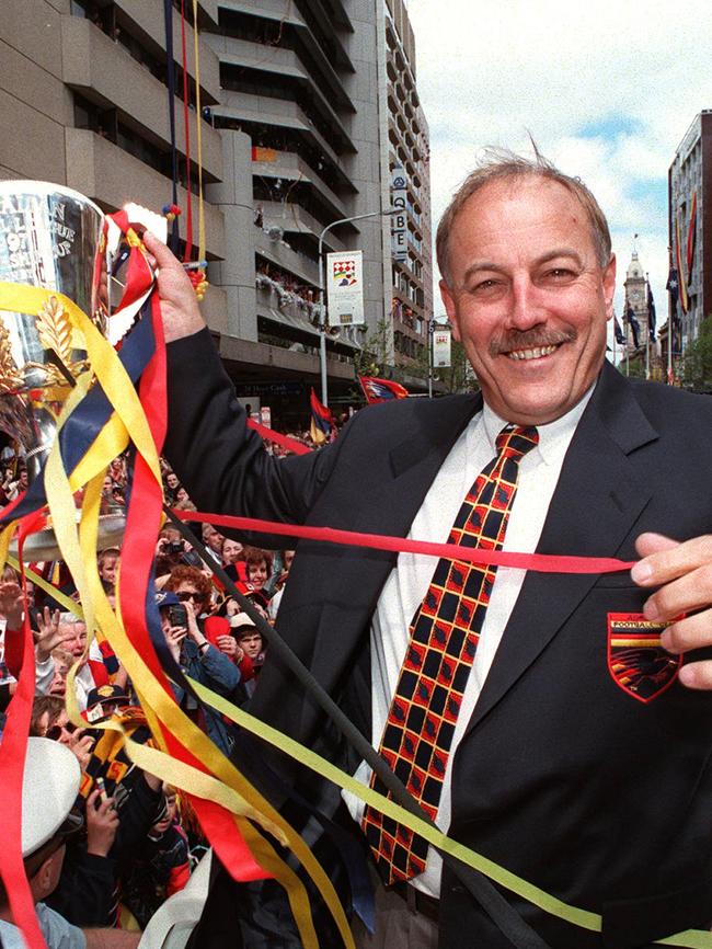 Coach Malcolm Blight holds on to the premiership cup during the Town Hall parade.