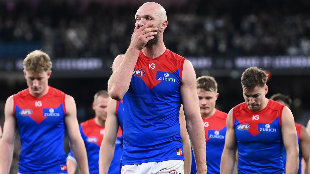 Melbourne players, including skipper Max Gawn, leave the ground after their loss to Collingwood in the qualifying final. Picture: Getty Images