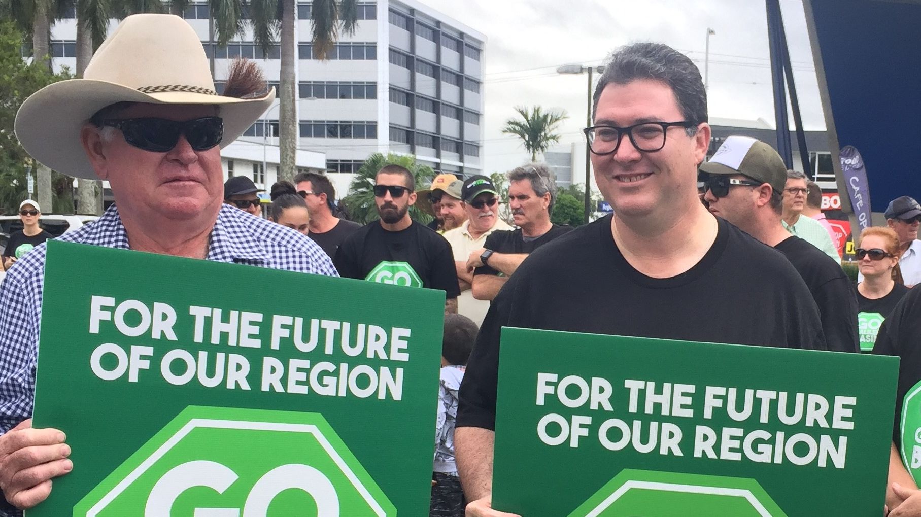 George Christensen waves a green banner as pro-mining activists await Bob Brown's convoy. 