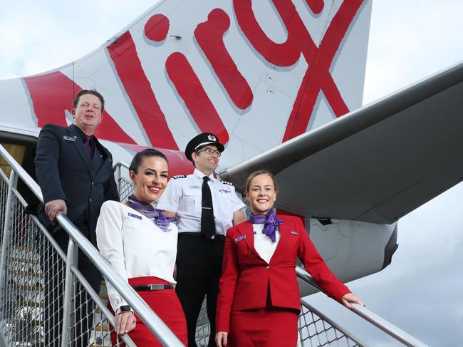 10/3/21: L to R..Nico Porter(CS), Bianca Yates, Captain Paul Anderson and Delia Taylor at Sydney airport. Virgin Australia crew are set to benefit from a suite of assistance measures being rolled out by the federal government to help airlines and the tourism industry continue to recover. John Feder/The Australian.