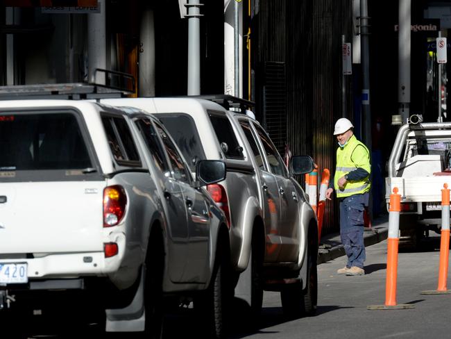 Builders' vehicles took up many of the city's parking spaces this morning as more tradies and workers associated with the construction industry were allowed to go back to work after Sunday's easing of Stage 4 restrictions. Picture: Andrew Henshaw