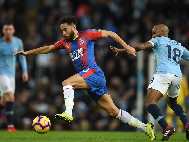 Crystal Palace's English midfielder Andros Townsend (L) beats Manchester City's English midfielder Fabian Delph (R) during the English Premier League football match between Manchester City and Crystal Palace at the Etihad Stadium in Manchester, north west England, on December 22, 2018. (Photo by Oli SCARFF / AFP) / RESTRICTED TO EDITORIAL USE. No use with unauthorized audio, video, data, fixture lists, club/league logos or 'live' services. Online in-match use limited to 120 images. An additional 40 images may be used in extra time. No video emulation. Social media in-match use limited to 120 images. An additional 40 images may be used in extra time. No use in betting publications, games or single club/league/player publications. /