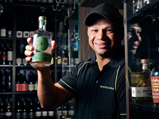 Daniel Motlop with his Australian green ant gin at Parap Fine Foods which has become a top selling gin around the world