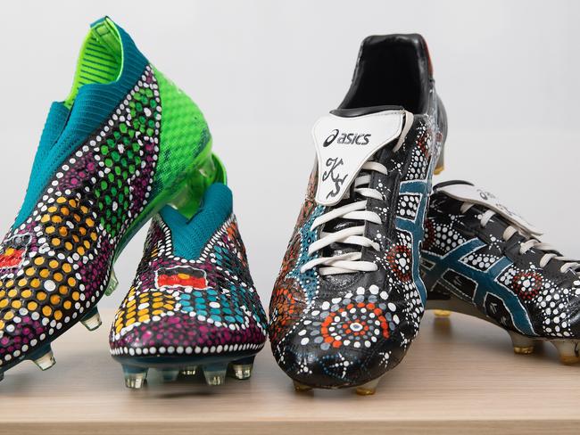 Players from the Tigers, Knights, Titans and Warriors will all wear specially designed boots with Indigenous themes, with boots auctioned off following matches this weekend. Cultural Choice display shoes painted for the NRL Indigenous Round 2020. Left to right: Mose Mbye's and Benji Marshall's boots. Pic: Paul Barkley / Supplied