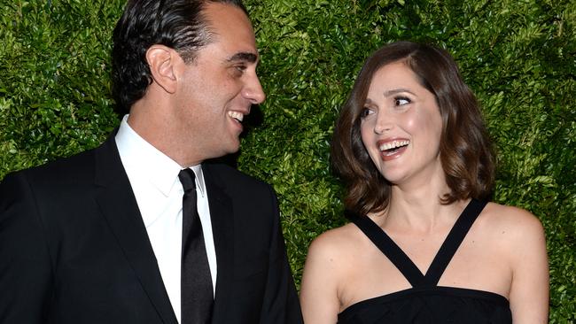 Rose Byrne shows off her growing baby bump on the red carpet.