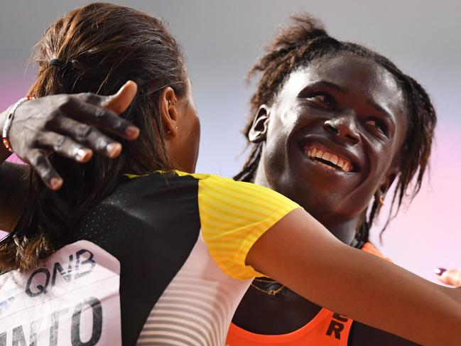 Niger's Aminatou Seyni (R) is congratulated by Germany's Tatjana Pinto  after competing in the Women's 200m heats at the 2019 IAAF Athletics World Championships at the Khalifa International Stadium in Doha on September 30, 2019. (Photo by Jewel SAMAD / AFP)