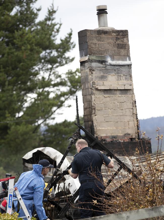 Police and fire investigators at the scene of a house fire at Fourfoot Rd, Geeveston. Picture Chris Kidd