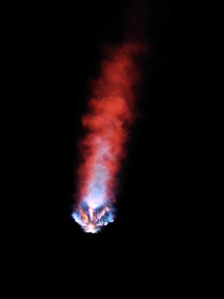 The burner from the recycled rocket after launch at 5.49am Eastern Time. Picture: Gregg Newton / AFP