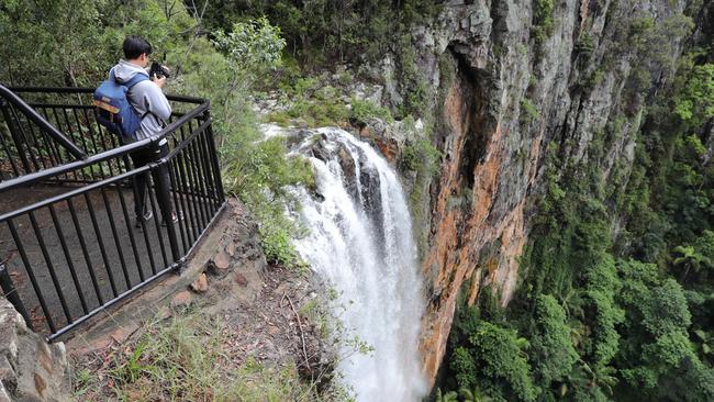 A tourist at Purlingbrook Falls in Springbrook National Park. Picture: Glenn Hampson.