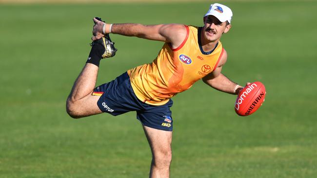 Adelaide’s Taylor Walker stretches at a Crows training session at West Lakes on Thursday. Picture: AAP