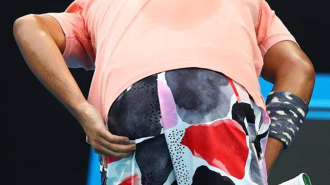 Nick Kyrgios grabs his derriere during the marathon win over Karen Khachanov. Picture: Getty Images