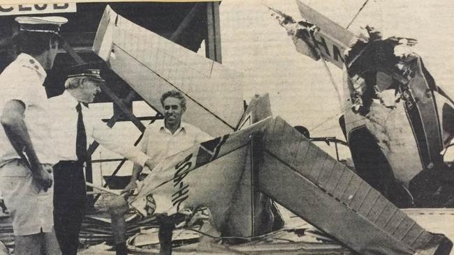 Captain Alan Walker, Commissioner Harry Warren and engineer Willie Pederson inspect the wrecked Salvation Army plane in the wake of Cyclone Tracy. Picture: Supplied