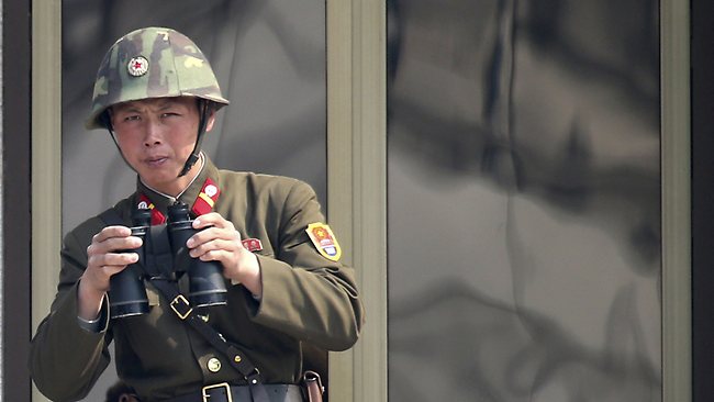 A North Korean soldier watches the South Korean side at the border village of Panmunjom in the demilitarized zone (DMZ) in South Korea.