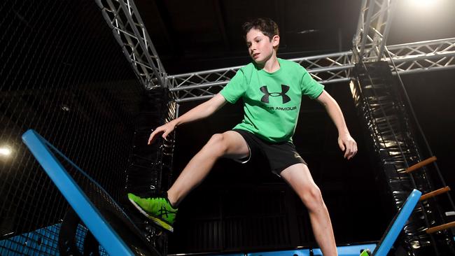 Rocco Pini, 12, enjoys himself on the Gorilla Warrior course at The Jungle Adventure Play at Tingalpa. Picture: John Gass
