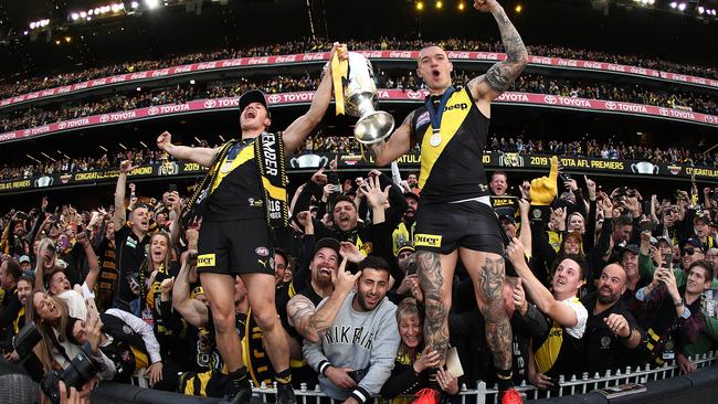 Fans surround Dustin Martin and Liam Baker as the Tigers celebrating winning the 2019 Grand Final. Picture: Getty Images