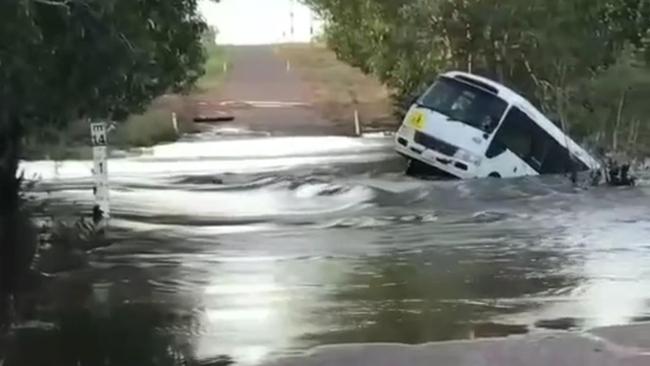 A CDC bus was swept into the floodwaters of the Finniss River with three Batchelor Area School children on board. Picture: Supplied.