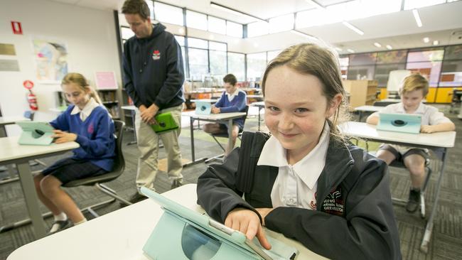 Sacred Heart Catholic School student Summah Taylor, 8, with Lily Longfield, 11, left, teacher Daniel McIntosh, Kohen Gilliland, 10, and Alex Skerke, 8, during NAPLAN testing. Picture: EDDIE SAFARIK