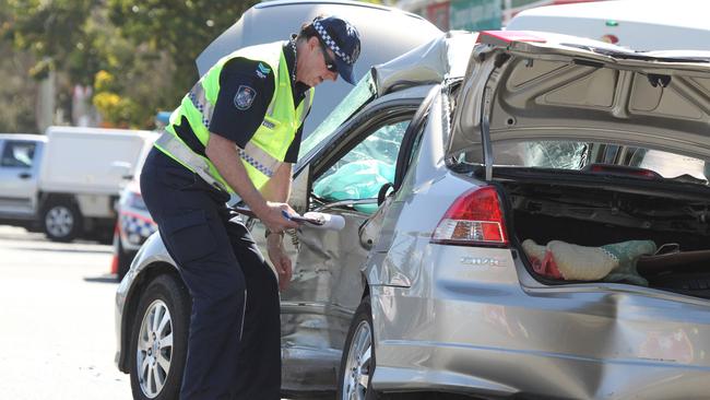 An officer on scene at a fatal crash along the Gold Coast Highway. 