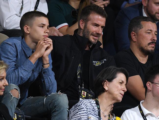 David Beckham (centre) and son Romeo (left) are seen in the crowd during the Wheelchair Basketball Final at the Invictus Games in Sydney. Picture: AAP