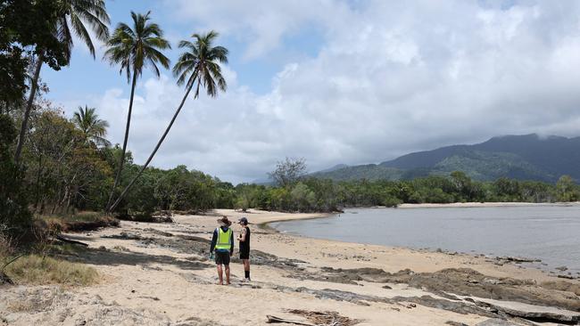 Audrius Macernis (left) speaks with a Trinity Beach local at Taylor Point before escorting him off his property. Picture: Brendan Radke