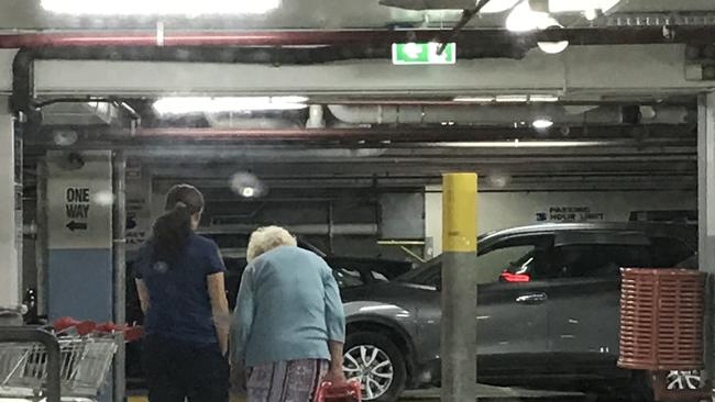 An elderly shopper is given a helping hand at Coles New Farm. Picture: Andrea Macleod