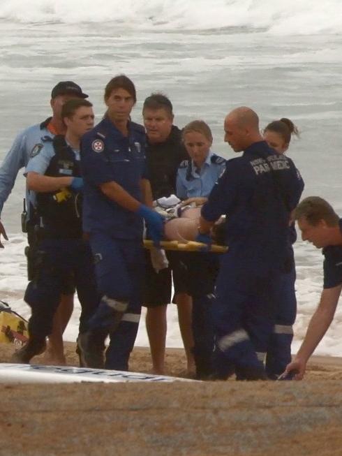 Josh Bush is brought from the water after he was struck by lightning. Picture: TNV