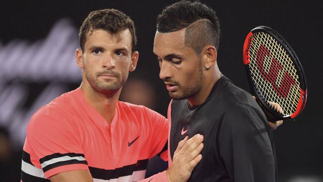 Grigor Dimitrov and Nick Kyrgios come together at the net after the Bulgarian’s four-set win in the fourth round match. Picture: AP.