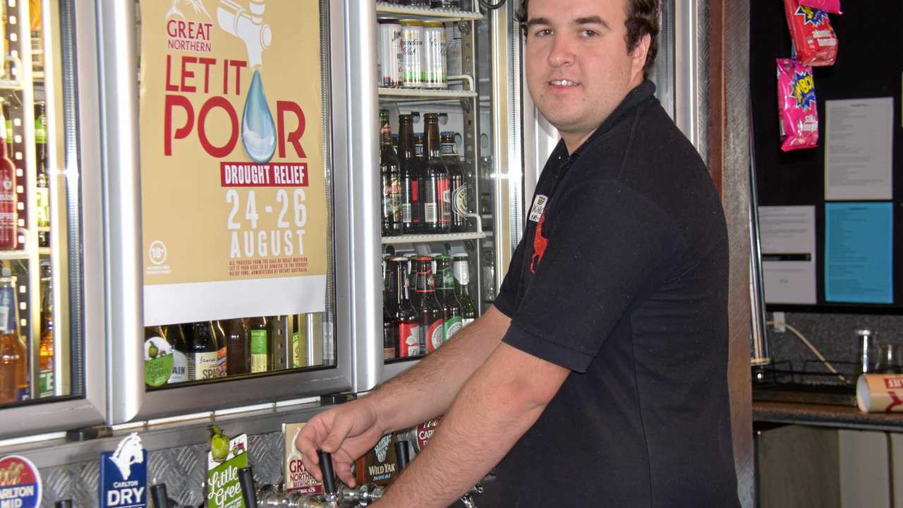 LET IT POUR: Callum Allery serves up another beer at the Kingaroy Hotel raising money for drought relief. Picture: Matt Collins