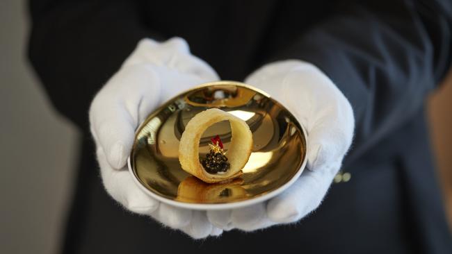 A butler offers an appetiser with caviar. Picture: Supplied