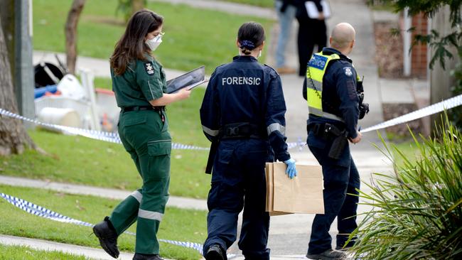 Forensic officers collecting evidence. Picture: Andrew Henshaw