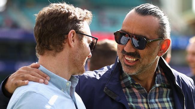 Adam Goodes (right) and 2012 premiership teammate Alex Johnson share a moment during Saturday’s 10-year reunion. Picture: Getty Images