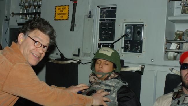 US Senator Al Franken poses for a photo where he appears to grope broadcaster Leeann Tweeden.