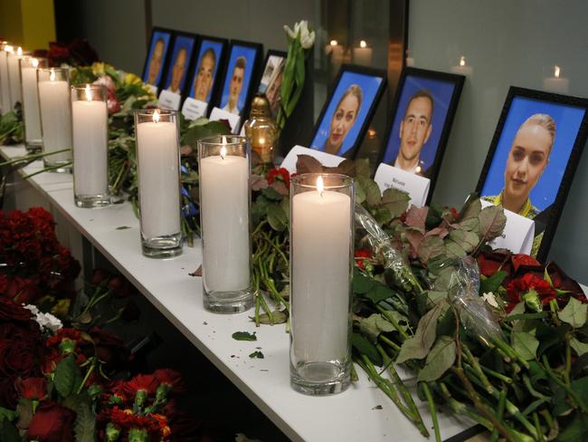 Flowers and candles are placed in front of portraits of the flight crew members of the Ukrainian 737-800 plane that crashed. Picture: AP