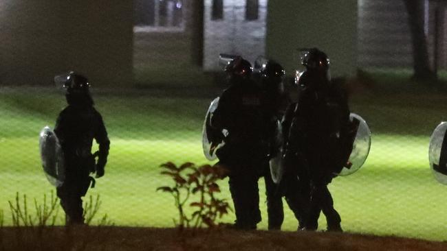 Police work to remove detainees from the roof. Picture: John Grainger