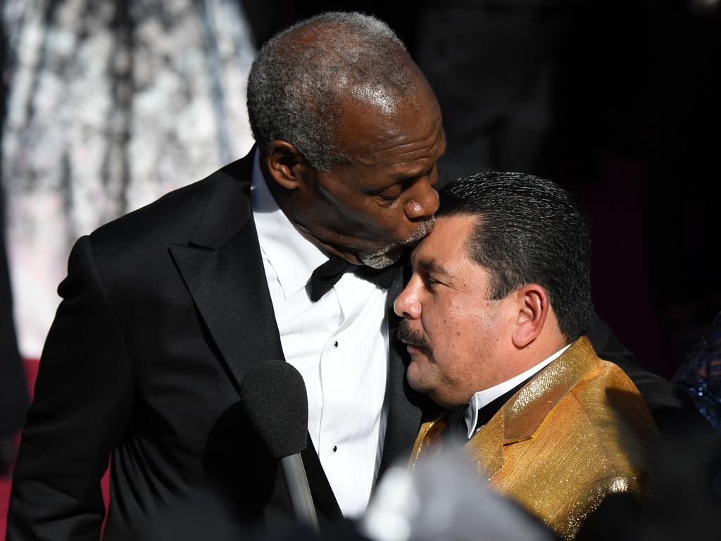 Danny Glover kisses tv host Guillermo on the head at the 90th Annual Academy Awards on March 4, 2018 in Hollywood, California. Picture: AFP