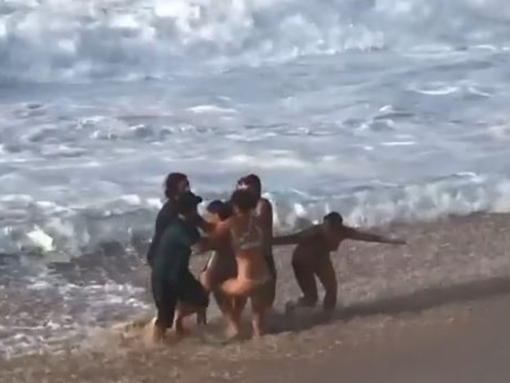 Others were soon able to help drag the woman from the surf.