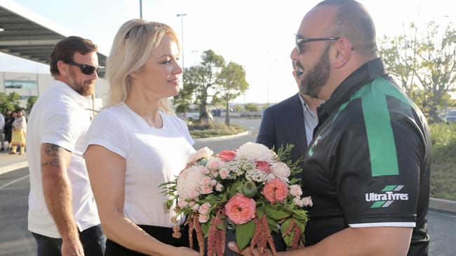 Pamela Anderson arriving into Brisbane Airport ahead of a week on the Gold Coast. She was greeted and given welcome flowers by her limo driver Jimmy Seoud. Pictures: Nathan Richter.