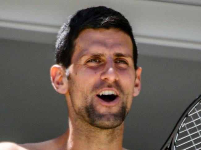 Men's world number one tennis player Novak Djokovic of Serbia responds to fans from a hotel balcony in Adelaide, South Australia on January 20, 2021, one of the locations where players have quarantined for two weeks upon their arrival ahead of the Australian Open tennis tournament in Melbourne. (Photo by Morgan SETTE / AFP) / -- IMAGE RESTRICTED TO EDITORIAL USE - STRICTLY NO COMMERCIAL USE --