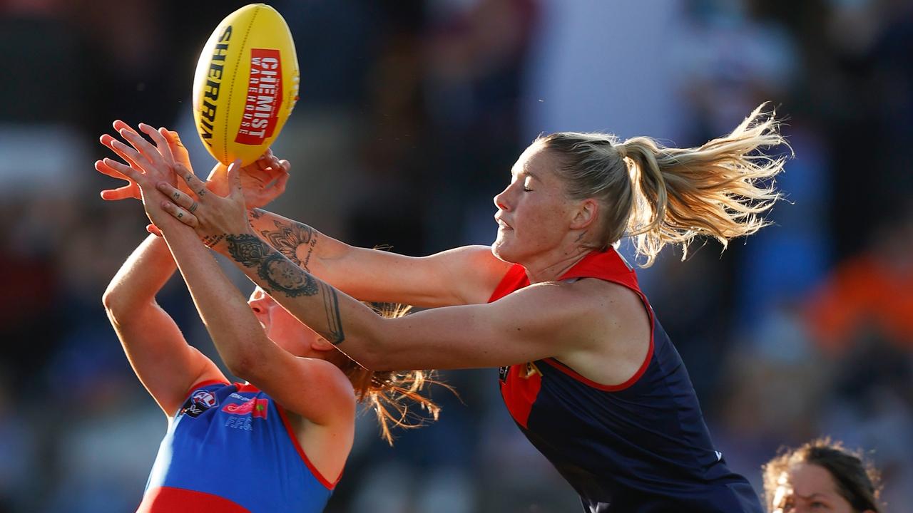 Tayla Harris tries to jump over Eleanor Brown on her Melbourne debut.