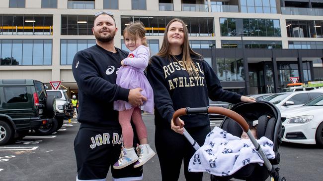 Aaron London and Riki McClure with children Rylee, 4, and Troy, three months, in the car park of the new Norwood Mall shopping centre. Picture: Mark Brake