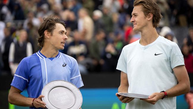 Asutralia's Alex de Minaur (L) celebrates with the trophy after winning against US' Sebastien Korda after their men's singles final match of Rosmalen Grass Court Championships tennis tournament in Rosmalen, near Hertogenbosch, on June 16, 2024. (Photo by Sander Koning / ANP / AFP) / Netherlands OUT