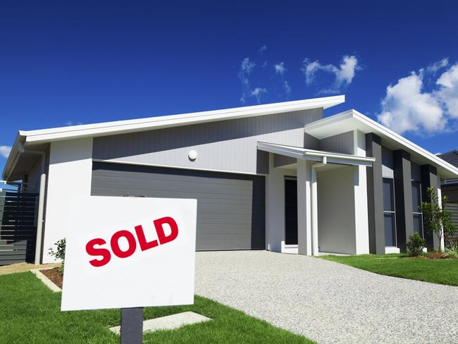 New suburban Australian house with SOLD sign.