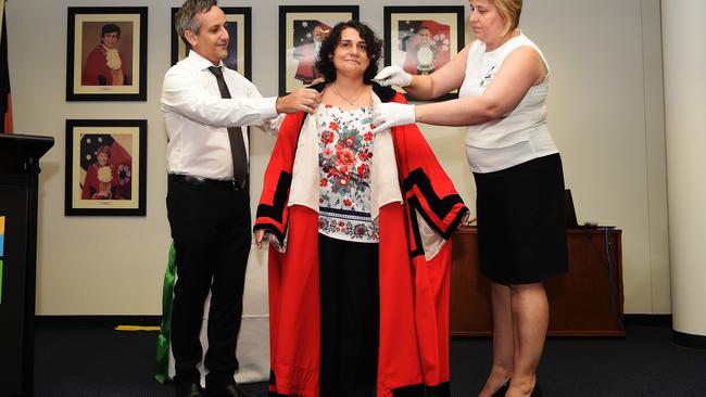 CEO of Palmerston Luccio Cercarelli helps put the mayoral robes on Athina Pascoe-Bell at the inauguration of a prior council. Picture: Keri Megelus