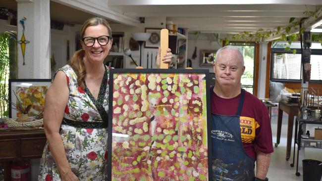 Gympie artist Willy Webster and mentor Sandra Ross show off one of his works to be displayed at the Gympie Regional Gallery.