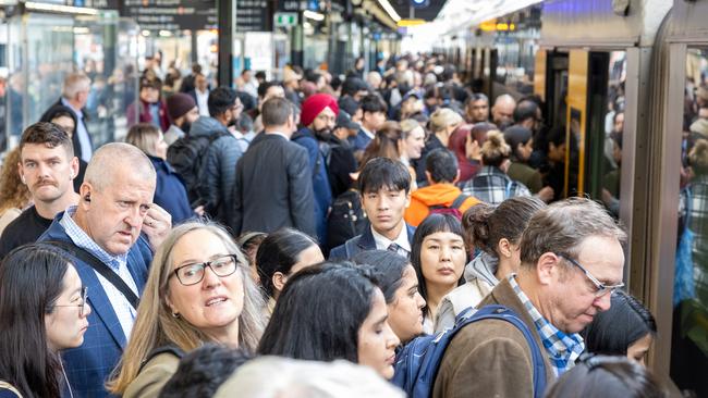 A mass of people leaving a train at Central Station on Wednesday after lengthy delays. Picture Thomas Lisson